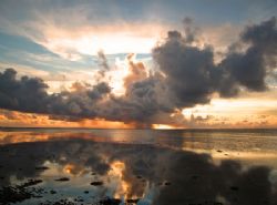 Squall at sunrise, Kosrae. by George Mcguire 